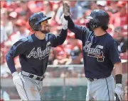  ?? John Minchillo / The Associated Press ?? Atlanta’s Ender Inciarte (left) celebrates with Dansby Swanson after hitting a three-run home in the third inning.