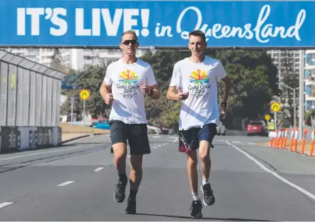  ?? Picture: GLENN HAMPSON ?? Supercars driver Will Davison (left) and marathon runner Michael Shelley check out the GC600 track.