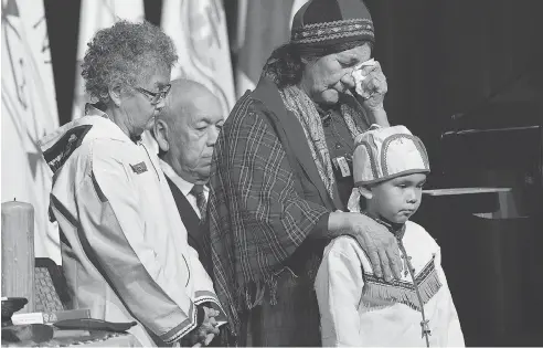  ?? ANDREW VAUGHAN / THE CANADIAN PRESS ?? Elders offer prayers before Prime Minister Justin Trudeau delivered an apology to former residentia­l school students on Friday in Newfoundla­nd.