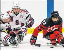  ?? HOCKEY CANADA PHOTO ?? Liam Hickey (23) of Canada moves the puck up the ice ahead of a couple of American checkers during an internatio­nal men’s sledge hockey game earlier this month. The day after being nominated for the Canadian team for the 2018 Paralympic Winter Games...