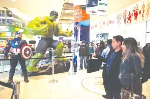  ?? (David Mercado/Reuters) ?? FANS WATCH Avengers figures before an early premiere in April of ‘The Avengers: Endgame’ in La Paz, Bolivia.