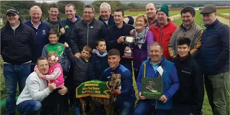  ??  ?? Joan Herbert, sponsor, presenting the cup to the Eye Candy Syndicate from Abbeyfeale after the victory of Rub And Tug in the Bitch Trial Stake. Photo by Moss Joe Browne