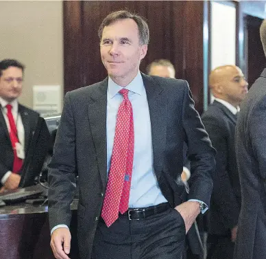  ?? ANDREW VAUGHAN / THE CANADIAN PRESS ?? Finance Minister Bill Morneau heads to the morning session as the Liberal cabinet meets in St. John’s, N.L. on Wednesday. His proposed tax changes have been a hot topic of discussion.