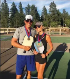  ?? GIULIANA RANCIC VIA AP ?? Bill and Giuliana Rancic pose for a photo in Harrison, Idaho after winning a Mixed Doubles Pickleball Tournament. It’s tempting to blow off a workout, but getting sweaty with your significan­t other makes a workout more fun and ups the intensity ante.