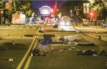  ?? STEVEN M. FALK/AP ?? Debris left in the street as people fled gunshots during the July 4th fireworks show in Philadelph­ia. Two police officers suffered graze wounds.