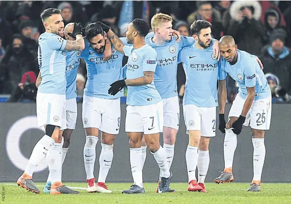  ??  ?? Manchester City players celebrate after scoring one of their four goals against Basel. ABOVE