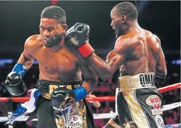  ?? AFP ?? Terence Crawford, right, punches Felix Diaz during their WBO/WBC junior welterweig­ht title bout.