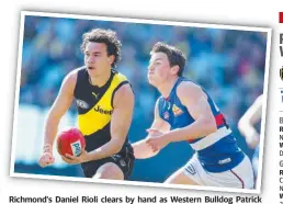  ?? Picture: MICHAEL KLEIN ?? Richmond's Daniel Rioli clears by hand as Western Bulldog Patrick Lipinski closes in