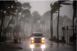  ?? - Reuters ?? CATEGORY 4 STORM: A vehicle drives along Ocean Drive in South Beach as Hurricane Irma arrives at south Florida, in Miami Beach, Florida, U.S. on Monday.