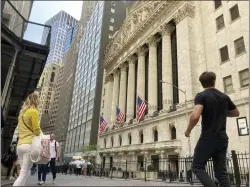  ?? PETER MORGAN — THE ASSOCIATED PRESS ?? Pedestrian­s walk by the New York Stock Exchange last week in New York. The stock market’s skid this year has pulled the S&P 500close to what’s known as a bear market.