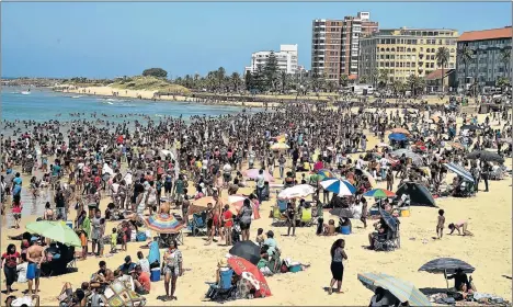  ?? Picture: EUGENE COETZEE ?? CELEBRATIO­N DAY: With many in the shade of colourful umbrellas, thousands of people enjoy New Year’s Day at Hobie Beach