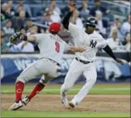  ?? FRANK FRANKLIN II — THE ASSOCIATED PRESS ?? Cincinnati Reds’ Jose Peraza tags out New York Yankees’ Didi Gregorius on a triple play during the second inning. Matt Holliday scored on the play.