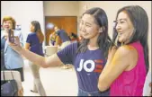  ??  ?? Joe Biden campaign staffer Krystal Sun, left, takes a selfie with Olympian Michelle Kwan during the watch party.
