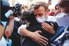  ?? Reuters ?? Emmanuel Macron comforts a resident during his tour of the devastated Gemmayzeh neighbourh­ood in Beirut yesterday.