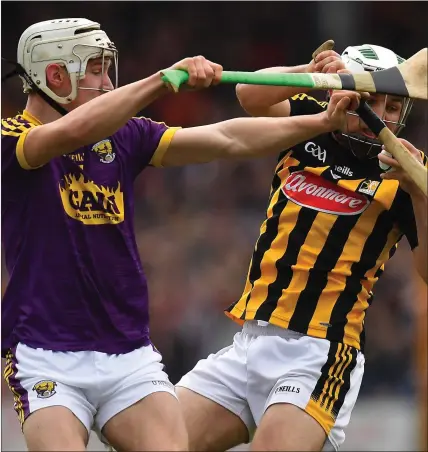  ??  ?? Wexford’s Cathal Dunbar putting pressure on Kilkenny full-back Pádraig Walsh.