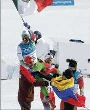  ?? DMITRI LOVETSKY / AP ?? Mexico’s German Madrazo holds up his country’s flag after finishing last in the men’s 15-kilometer freestyle cross-country skiing race.