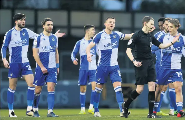  ??  ?? Bristol Rovers players surround referee Peter Wright following a foul on Brandon Hanlan by Charlton’s Deji Oshilaja