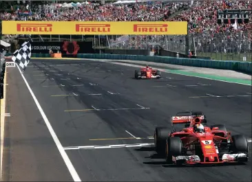  ?? Picture: ANDREJ ISAKOVIC, REUTERS ?? THE RED MACHINES RULE: Ferrari’s Sebastian Vettel and Kimi Raikkonen cross the finish line in first and second place respective­ly at the Hungarorin­g circuit in Budapest yesterday.