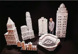  ?? BRYAN BERG ?? Bryan Berg, posing here with models of landmarks in Cincinnati, Ohio, says anyone can create structures from cards.