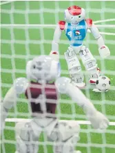  ??  ?? GOING FOR GOAL: A robot with a Luxembourg team shoots towards the goalkeeper of an Italian team at the RoboCup German Open 2017.