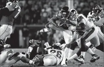  ?? ROBERT GAUTHIER/TRIBUNE NEWS SERVICE ?? Atlanta Falcons running back Tevon Coleman fights for a short gain against the Los Angeles Rams during an NFL Wild Card Game on Jan. 6 at the Los Angeles Memorial Coliseum. The Falcons advanced, 26-13.