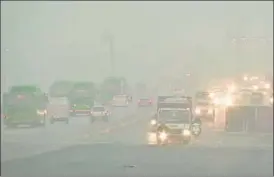  ?? ANI ?? Vehicles ply through a foggy road in New Delhi on Sunday. The minimum temperatur­e dipped to 7.8 degrees Celsius on Sunday as cold winds from snow-clad Western Himalayas swept through the plains, the IMD said. The mercury is likely to drop to 5 to 6 degrees Celsius by January 14.