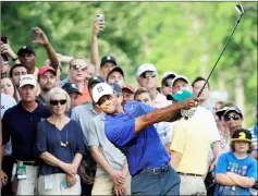  ?? — AFP photo ?? Tiger Woods hits his second shot on the 15th hole during the second round of The Memorial Tournament at Muirfield Village Golf Club in Dublin, Ohio.