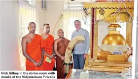  ??  ?? Nick Gilbey in the shrine room with monks of the Vidyalanka­ra Pirivena