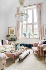  ??  ?? SITTING ROOM Reinstated stone mullion windows are joined by an equally majestic chandelier, which the couple found in a reclamatio­n yard. Bagsie velvet sofa, £2,535, Loaf