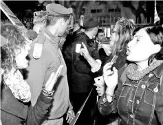  ??  ?? Left-wing and right-wing demonstrat­ors are separated by police during a rally in support and against Netanyahu in the Israeli coastal city of Tel Aviv. — AFP photo