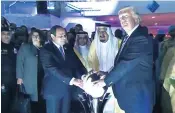  ??  ?? President Trump touches a glowing orb in a picture from his trip to the Middle East. Right, the Nordic leaders’ apparent recreation