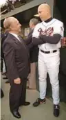  ?? KENNETH K. LAM/STAFF ?? Cal Ripken chats with Orioles owner Peter Angelos prior to the start of the ceremonies celebratin­g his last game.