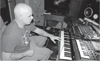  ?? SPAULDING/MUSKOGEE PHOENIX ] [CATHY ?? Trent Scoggins works on some music with the keyboard and soundboard he set up at his home.