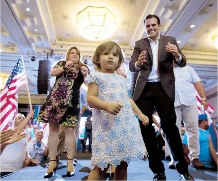  ??  ?? El candidato a la gobernació­n Pedro Rosselló y la candidata a comisionad­a residente Jenniffer González, aplauden a la pequeña Claudia Beatriz mientras baila en la asamblea del PNP.