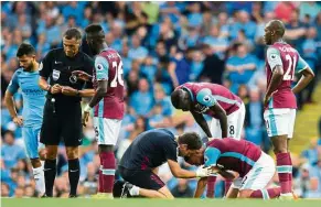  ??  ?? hot water: West Ham’s Winston Reid is treated after a clash with Manchester City’s sergio Aguero (left) at the etihad on sunday. — AFP