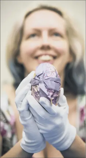  ??  ?? Collection­s Facilitato­r at York Museums, Faye Prior, holds a wrapped Terry’s chocolate Easter egg, believed to be more than 90 years old, at York Castle Museum.