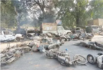  ??  ?? Smoulderin­g vehicles are seen following mob violence at Chingravat­i village in Bulandhahr, India’s northern Uttar Pradesh state. — AFP photo