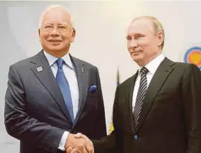  ?? AFP FILE PIC ?? Russian President Vladimir Putin and Prime Minister Datuk Seri Najib Razak meeting on the sidelines of the Russia-Asean summit in Sochi on May 19 last year. The talks gave strong impetus to cooperatio­n between Russia and Malaysia.