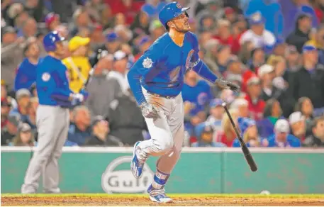  ?? | GETTY IMAGES ?? Kris Bryant watches his home run soar over the Green Monster in the fifth inning Sunday at Fenway Park.