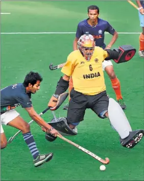  ?? MOHD ZAKIR/ HT ?? India hockey team captain and goalkeeper Bharat Chhetri (centre)blocks a move by his teammate Yuvraj during a training session at the National Stadium in New Delhi on Wednesday.