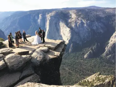  ?? Amanda Lee Myers / Associated Press ?? A couple are married atop Taft Point in Yosemite National Park in September. On Oct. 25, park rangers recovered the bodies of a young married couple who had fallen from the popular Yosemite overlook.