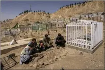  ?? BERNAT ARMANGUE, FILE - THE ASSOCIATED PRESS ?? In this Sept. 13file photo, the Ahmadi family pray at the cemetery next to family graves of family members killed by a US drone strike, in Kabul, Afghanista­n.