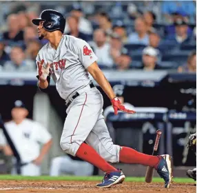  ??  ?? Red Sox shortstop Xander Bogaerts hits a single against the Yankees during Game 4 of the ALDS on Tuesday at in New York. NOAH K. MURRAY/USA TODAY SPORTS