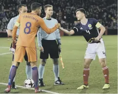 ??  ?? 0 Kieran Tierney, right, at the start of his night as Scotland captain.