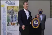  ?? DAMIAN DOVARGANES — THE ASSOCIATED PRESS ?? Gov. Gavin Newsom encourages California­ns to get vaccinated with the influenza and COVID-19vaccines ahead of the holidays after a visit to a COVID-19 vaccine clinic at the VA Greater Los Angeles Healthcare System in Los Angeles on Wednesday.