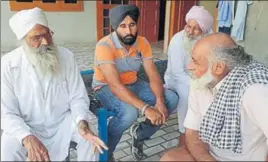  ?? HT PHOTO ?? Jasbir Singh’s father Nirbhai Singh (R) being consoled by neighbours at his house in Barnala.