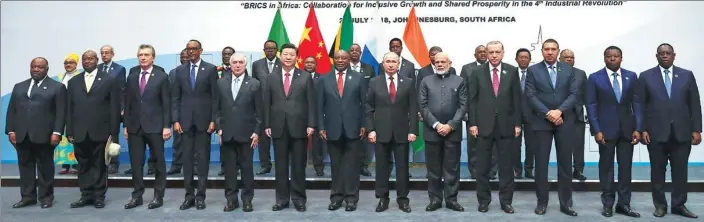  ?? AP ?? President Xi Jinping and other heads of state and government pose for a group picture at the BRICS outreach dialogue meeting in Johannesbu­rg, South Africa, on Friday.
