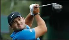  ?? Charlie Riedel / AP ?? Patrick Reed drives from the 18th tee during the third round at the Masters.