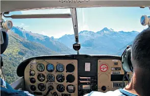  ??  ?? Clockwise from above: Siberia Valley, in Mount Aspiring National Park, seen from a Cessna light aircraft; lupins in Mount Cook National Park; and dolphin watching from the yacht Tarquin