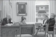  ?? AP PHOTO ?? In this Jan. 28, 2017, file photo, President Donald Trump speaks on the phone with Prime Minister of Australia Malcolm Turnbull, with then-National Security Adviser Michael Flynn, centre, and then-chief strategist Steve Bannon, right, in the Oval...